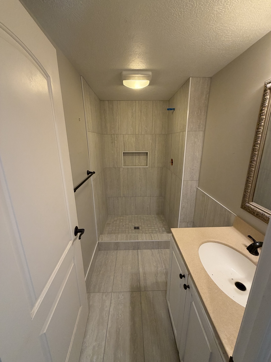 Tiled walk-in shower and bathroom