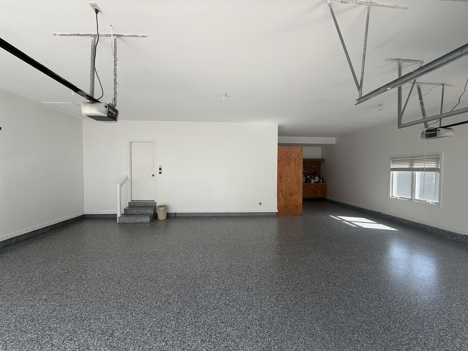 Large garage with gray flake epoxy floor