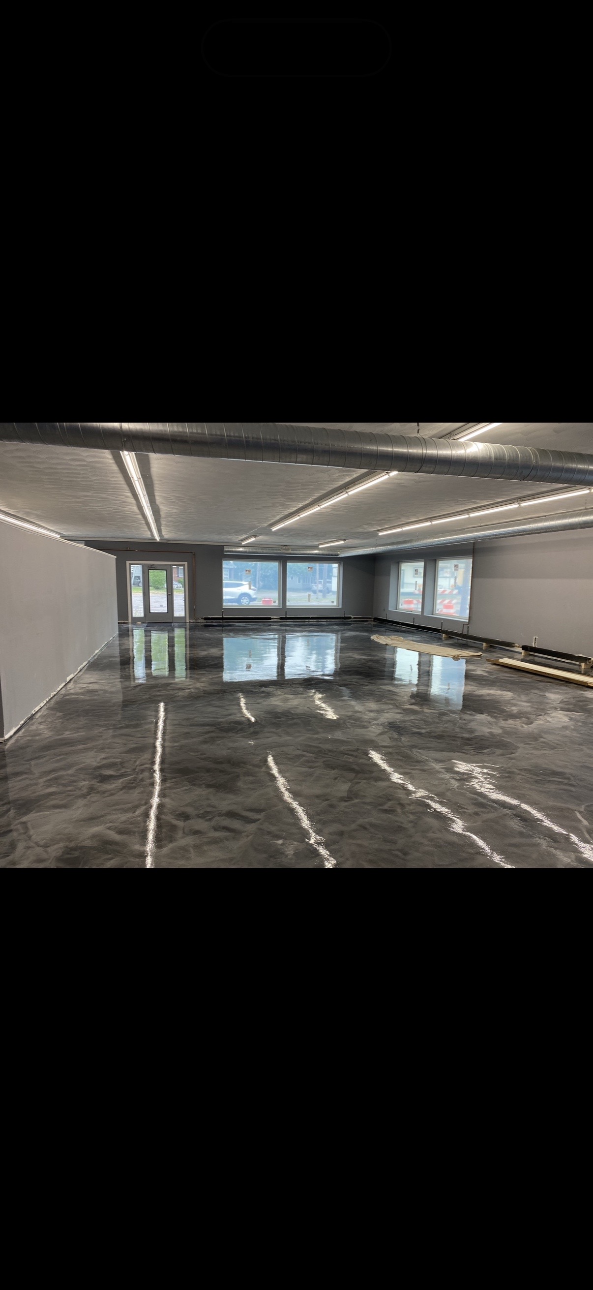 Glossy metallic epoxy floor installed by Liquid Flooring